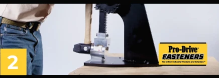 Pro-Drive Fasteners® Tipper-De-Tipper step 2 of 3: Lock the head under the arm and hold the handle.