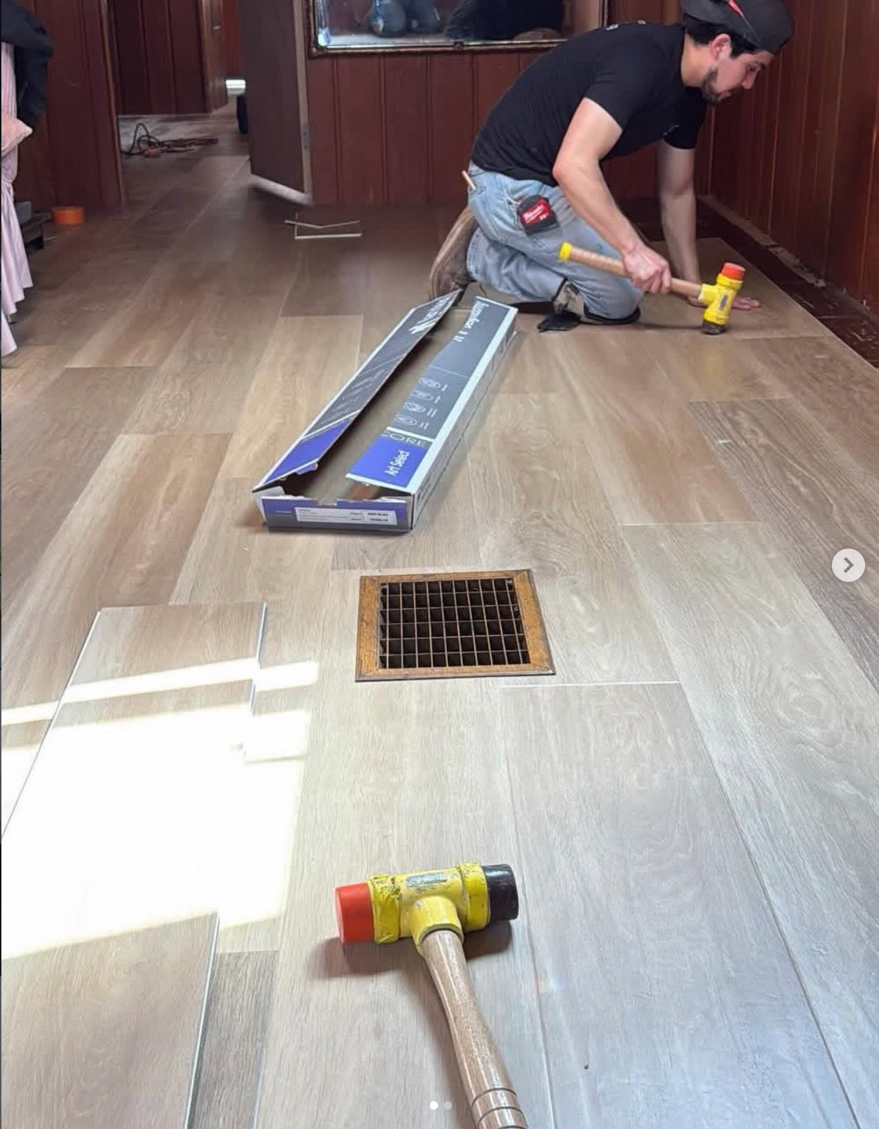 Installer using a Pro-Drive Fasteners® mallet while laying flooring around a floor vent