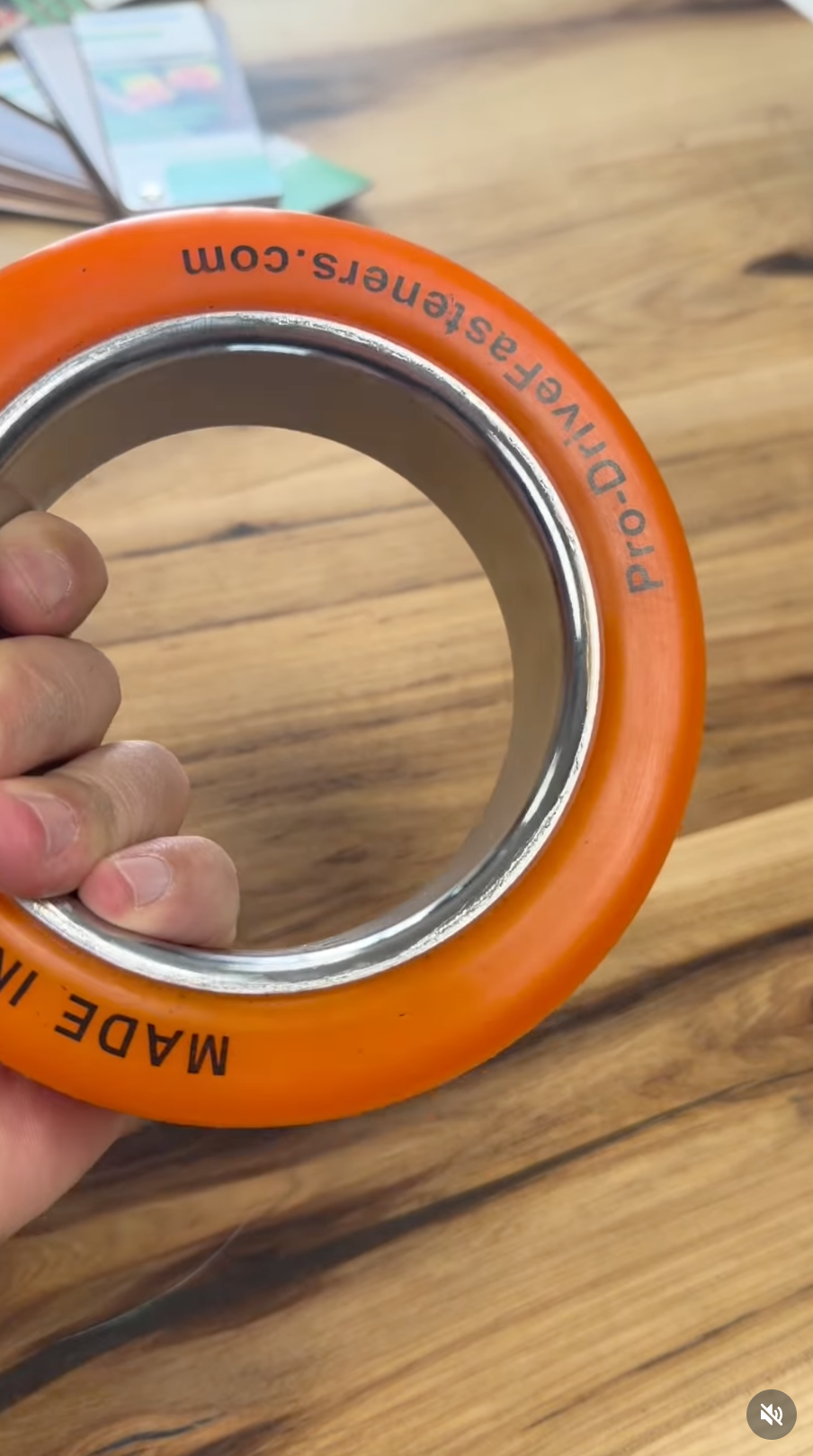 Close-up of an orange Pro-Drive Fasteners® tapping ring showing the printed branding